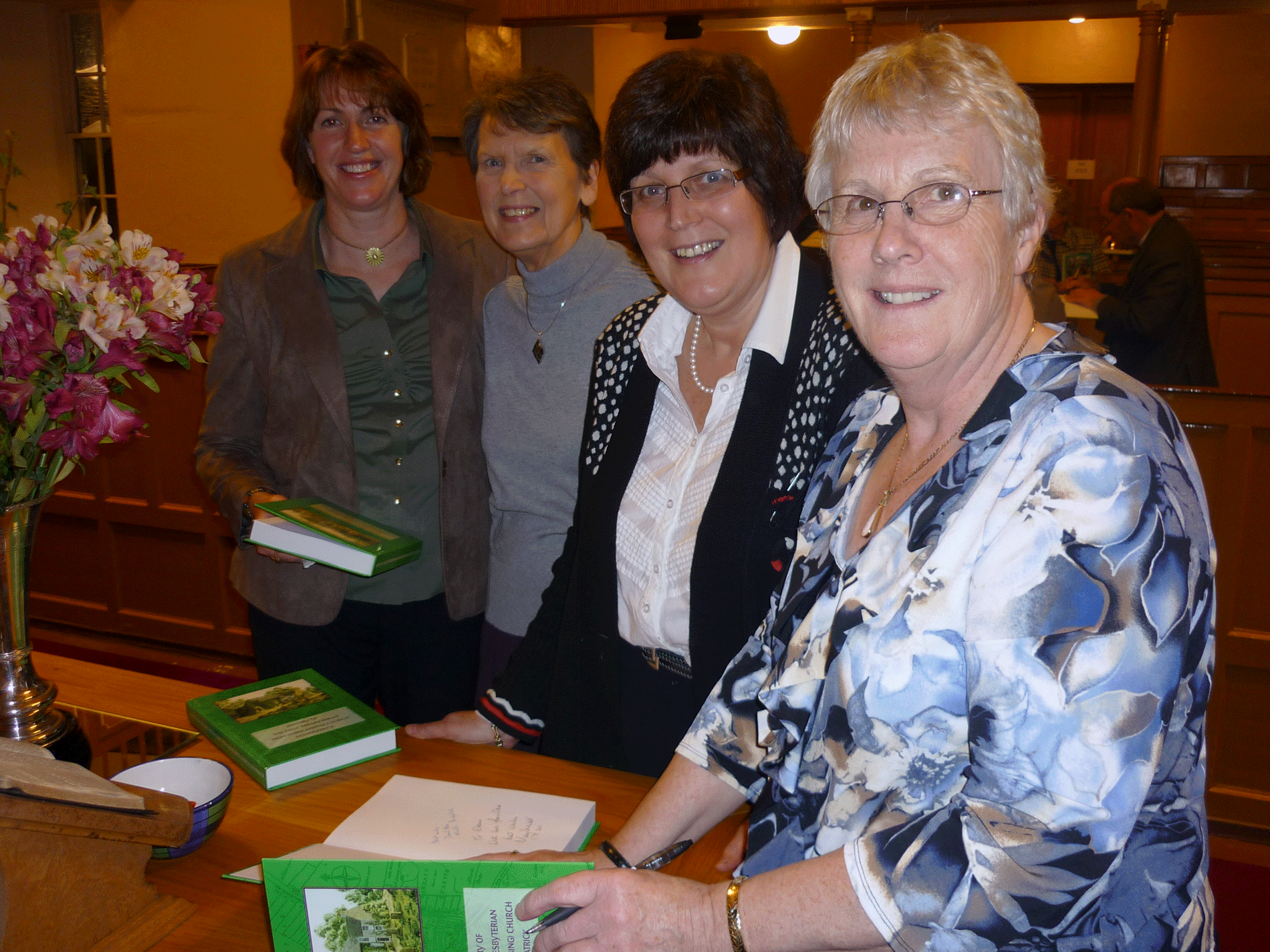 Mary signing her books for members of the congregation